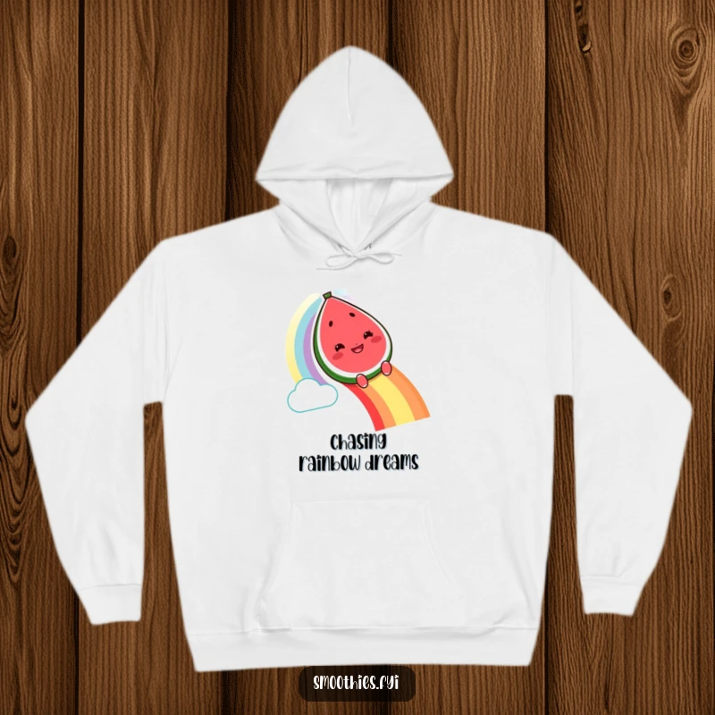 Funny grinning watermelon character hoodie sliding down a rainbow, cozy and humorous fruit clothing.
