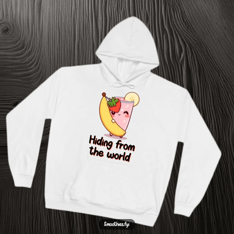 Funny shy smoothie hoodie featuring a strawberry smoothie peeking from behind a banana slice, its bashful look radiating sweet, gentle humor.