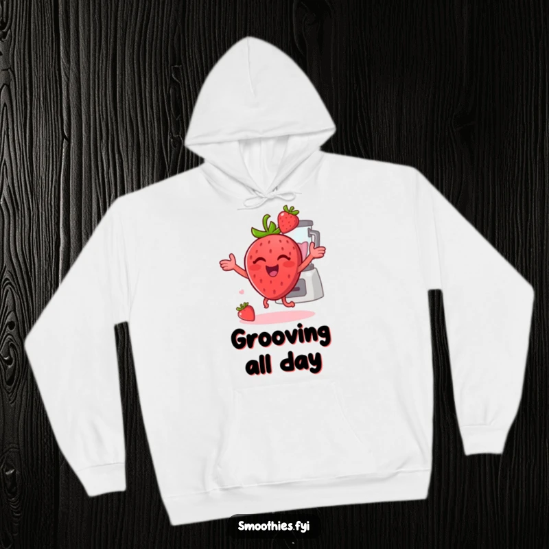 Funny strawberry dancing energetically with a blender behind it on a hoodie, offering cozy and humorous wear.