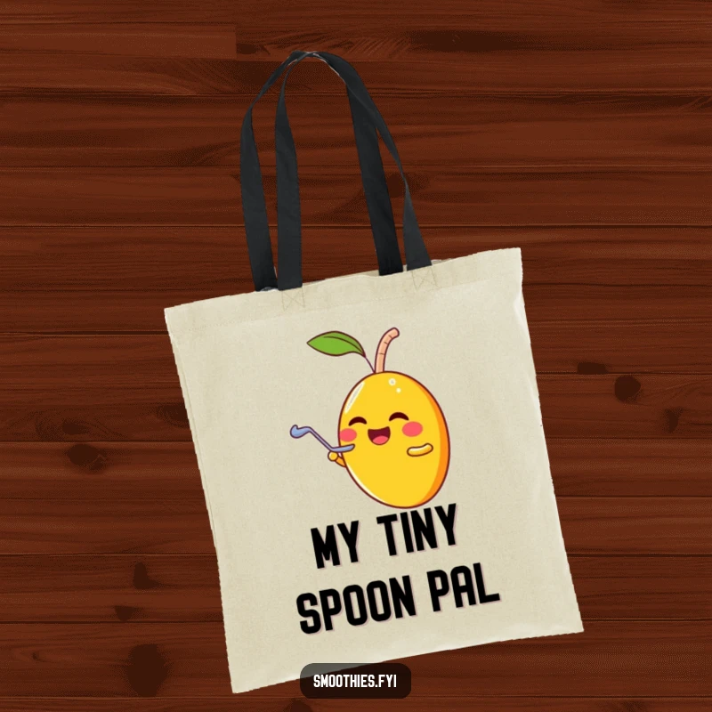Funny laughing mango character sharing a smoothie with a tiny spoon, printed on a sturdy tote bag.